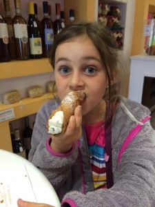 You'll often pleasantly surprised by the gluten-free items you can find while traveling. Here my daughter is enjoying gluten-free cannoli in Sorento, Italy.